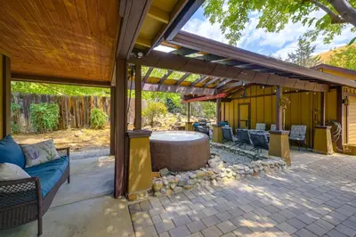 a patio with a table and chairs under a pergola at Idyllic Home in Kernville with Private Beach Access in Kernville