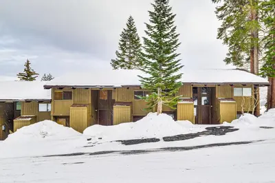 a house with a tree in the snow at Walk to Ski Lift Mtn-View Condo in Mammoth Lakes in Mammoth Lakes