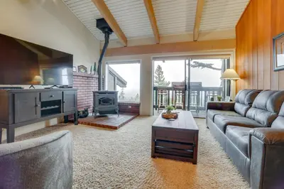 a living room with a couch and a stove at Walk to Ski Lift Mtn-View Condo in Mammoth Lakes in Mammoth Lakes