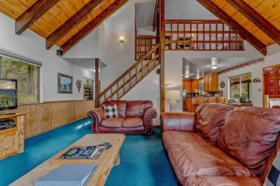 a living room with a couch and a table at Near Northstar Wooded Retreat with Deck & Loft in Tahoe Vista