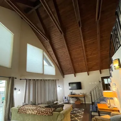 a living room with wooden ceilings and a couch at Spacious family home on the Meadow Monthly Only in South Lake Tahoe