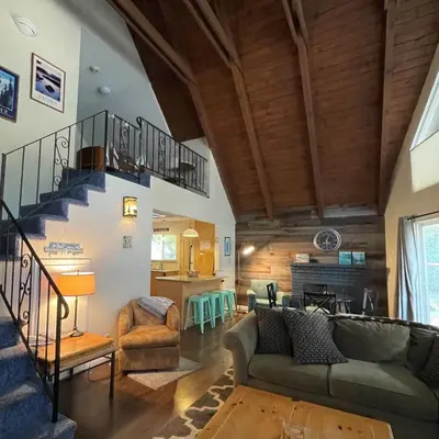 a living room with a staircase in a house at Spacious family home on the Meadow Monthly Only in South Lake Tahoe