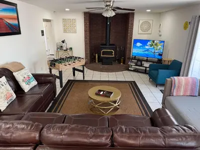 a living room with a couch and a fire place at Charming 3 Bedroom Farmhouse Retreat with Open Deck in Acampo
