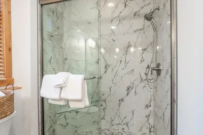a shower with a glass door in a bathroom at Solstice 17 in Mammoth Lakes