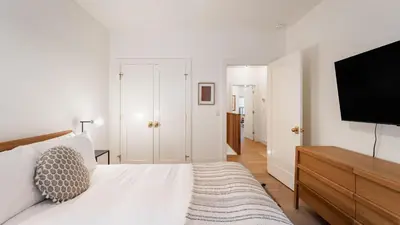 a white bedroom with a bed and a television at Northwood Mountain Views Sauna Balcony Tahoe Group Retreat in Incline Village