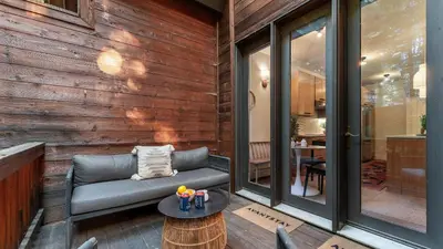 a patio with a couch and a table at Northwood Mountain Views Sauna Balcony Tahoe Group Retreat in Incline Village