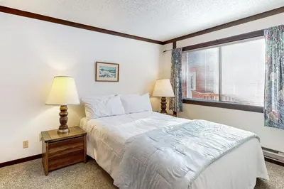 a bedroom with a large bed and a window at Tahoe Tranquility in Incline Village