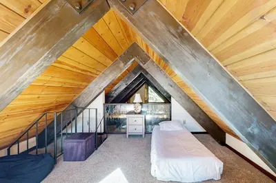 an attic room with two beds and a staircase at Tahoe Tranquility in Incline Village