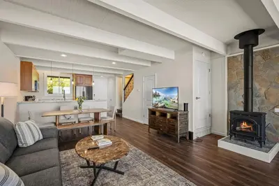 a living room with a couch and a fireplace at Newley remodeled, two story, two-bedroom condo nothing but Views of Lake Tahoe! in Incline Village