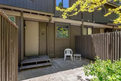 a wooden house with a chair and a door at Newley remodeled, two story, two-bedroom condo nothing but Views of Lake Tahoe! in Incline Village