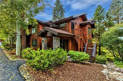 a log home with a staircase leading up to it at Third Creek- Experience the Ultimate in Luxury in Incline Village