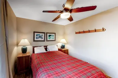 a bedroom with a bed and a ceiling fan at Crestview 48 in Mammoth Lakes