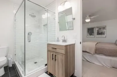a bathroom with a shower and a sink and a toilet at Luxury Lake Home-The Bear Claw-Boat Slip-Sleeps 16 in Bass Lake