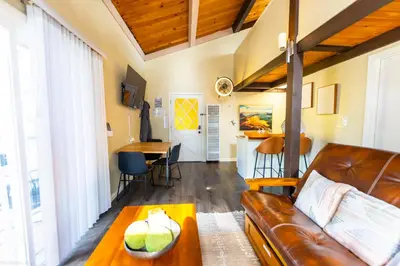 a living room with a leather couch and a table at Mountain Serenity, near Ski, Golf, Casino, Lake in Stateline