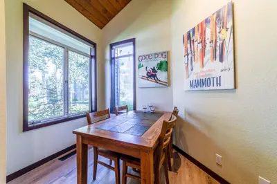 a dining room with a wooden table and chairs at Grand Townhome w/ Meadow Views; Private Garage in Mammoth Lakes