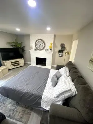 a living room with a bed and a couch at Entire House in Old Fig Garden in Fresno