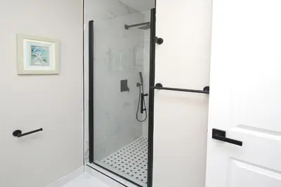 a shower with a glass door in a bathroom at Entire House in Old Fig Garden in Fresno