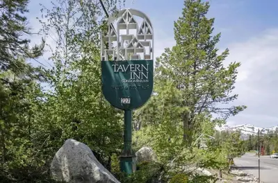 a street sign on a pole with some rocks at 2 Miles to Palisades Ski Resort w Free Shuttle! in Olympic Valley