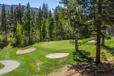 an overhead view of a golf course with trees at Mammoth Green #210 - Nearly Ski-in Ski-Out 2 Bedroom 2 Bath, Sleeps 6 on Golf Course in Mammoth Lakes