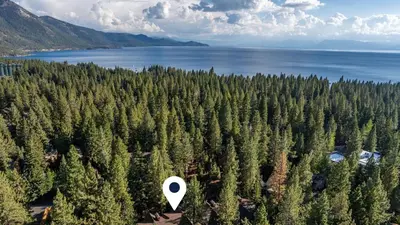 an aerial view of a forest of trees next to the water at Walk to Lake DiningShops 5mins to Ski Resort Incline Paradise by AvantStay in Incline Village