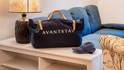 a black bag sitting on a table next to a couch at Walk to Lake DiningShops 5mins to Ski Resort Incline Paradise by AvantStay in Incline Village
