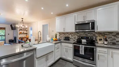 a kitchen with white cabinets and white appliances at Walk to Lake DiningShops 5mins to Ski Resort Incline Paradise by AvantStay in Incline Village