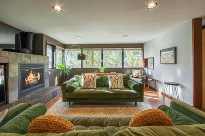 a living room with a couch and a fireplace at Spire Chalet at Alpine Meadows - 4BR W Hot Tub and Ski Shuttle in Alpine Meadows