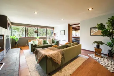 a living room with a couch and a table at Spire Chalet at Alpine Meadows - 4BR W Hot Tub and Ski Shuttle in Alpine Meadows