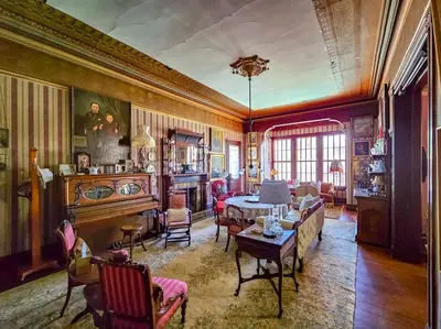 a living room filled with furniture and a table at The JD Hyde Historic Inn in Visalia