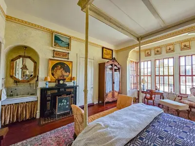 a bedroom with a bed and a fireplace at The JD Hyde Historic Inn in Visalia