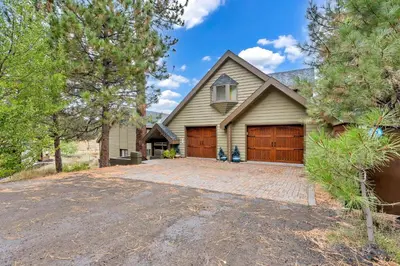 a house with a driveway and a garage at Secluded Tahoe Retreat by Northstar with Hot Tub in Truckee