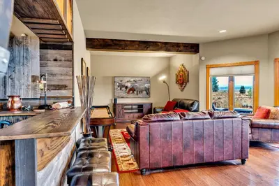 a living room with a couch and a table at Secluded Tahoe Retreat by Northstar with Hot Tub in Truckee