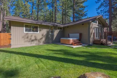 a small house with a hot tub in a yard at Luxury Single Level, Great Location, Hot Tub, Arcade in South Lake Tahoe
