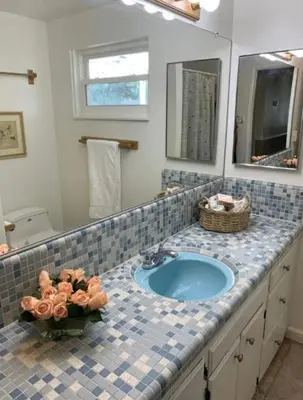 a bathroom with a sink and a mirror at Midtown Old Southwest Home With Pool! in Reno