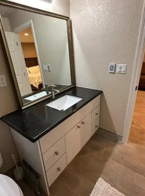 a bathroom with a sink and a large mirror at Private Old Southwest Casitas in Reno