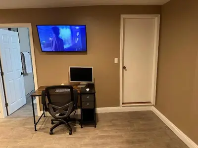 a desk with a computer and a monitor on a wall at Private Old Southwest Casitas in Reno