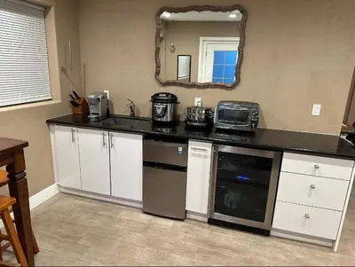 a kitchen with a counter with a sink and a microwave at Private Old Southwest Casitas in Reno