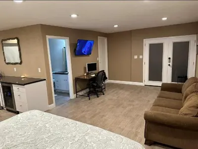 a living room with a couch and a desk with a computer at Private Old Southwest Casitas in Reno