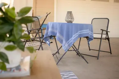 a table and chairs with a blue cloth on it at 1 BR Orchard Cottage - Gateway to Two National Parks! in Visalia