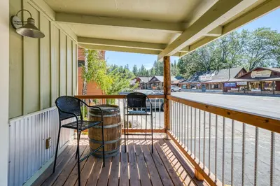 a porch with two chairs and a barrel at Cottage Like Suite with Private Hot Tub in Bass Lake