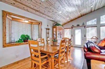 a dining room with a wooden table and chairs at Serenity Pines in Yosemite West