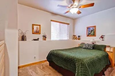 a bedroom with a bed and a ceiling fan at Serenity Pines in Yosemite West