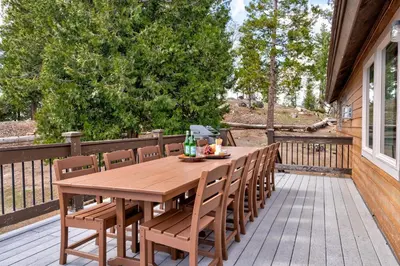 a wooden table and chairs on a deck at Yosemite Summit & Little Summit in Yosemite West