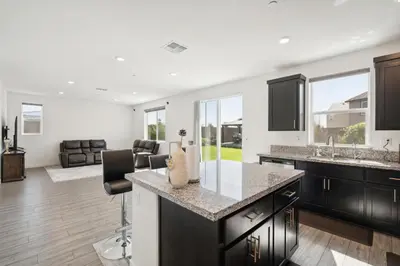 a kitchen with a counter top and a living room at Spacious 3BR Home with Charming Backyard home in Folsom