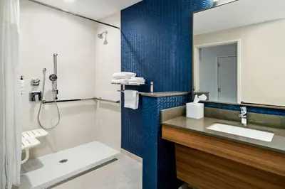 a bathroom with a sink and a shower at Fairfield Inn & Suites Hanford in Hanford