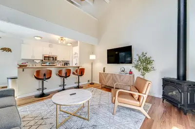 a living room with a table and a stove at 5 Mi to Northstar Skiing Bear Den Home with Decks in Kings Beach