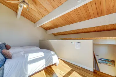 a bedroom with a bed and a wooden ceiling at 5 Mi to Northstar Skiing Bear Den Home with Decks in Kings Beach