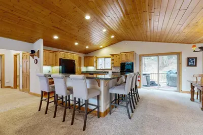 a kitchen with a bar with stools at Vista Pines Retreat in Tahoe Vista
