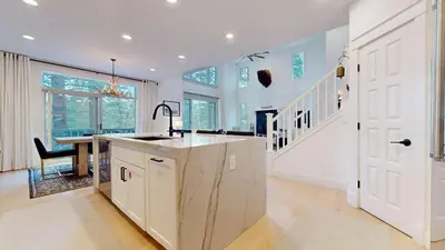 a kitchen with a sink and a table in a room at Timbers #12 townhouse in Mammoth Lakes