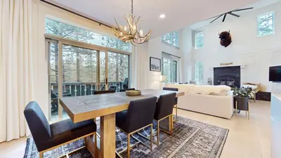 a dining room and living room with a table and chairs at Timbers #12 townhouse in Mammoth Lakes
